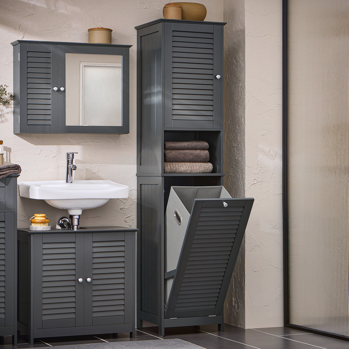 Slim grey freestanding bathroom storage unit with shelves in laundry room setting