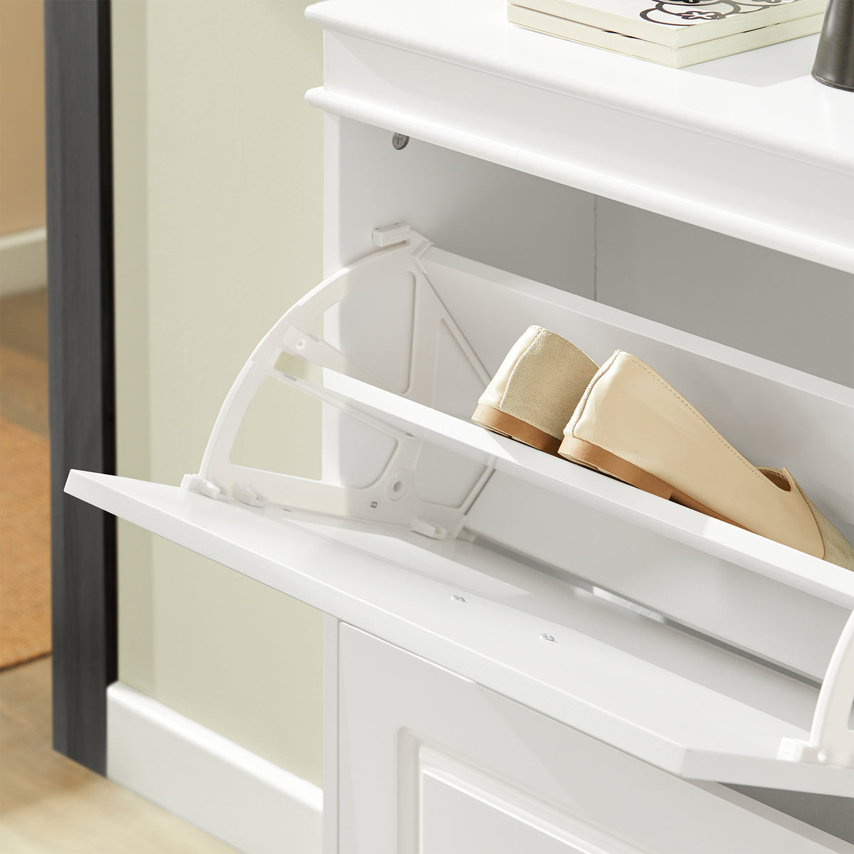 flip drawer open on white shoe cabinet showing 2-tier internal rack