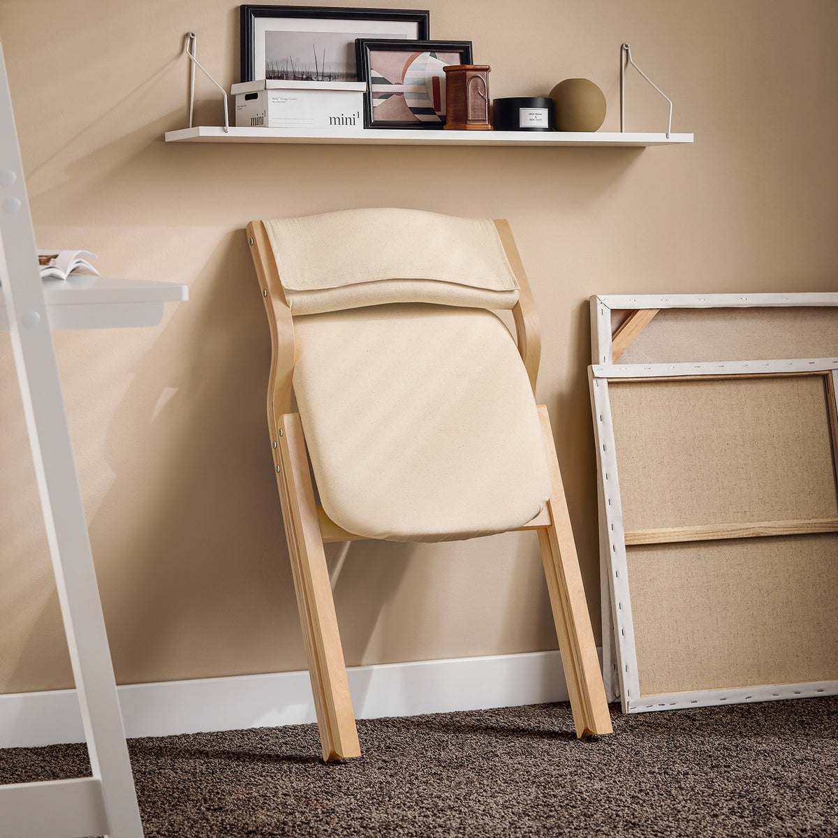 SoBuy FST40-W folded flat for storage detail – slim profile white folding chair stored against wall