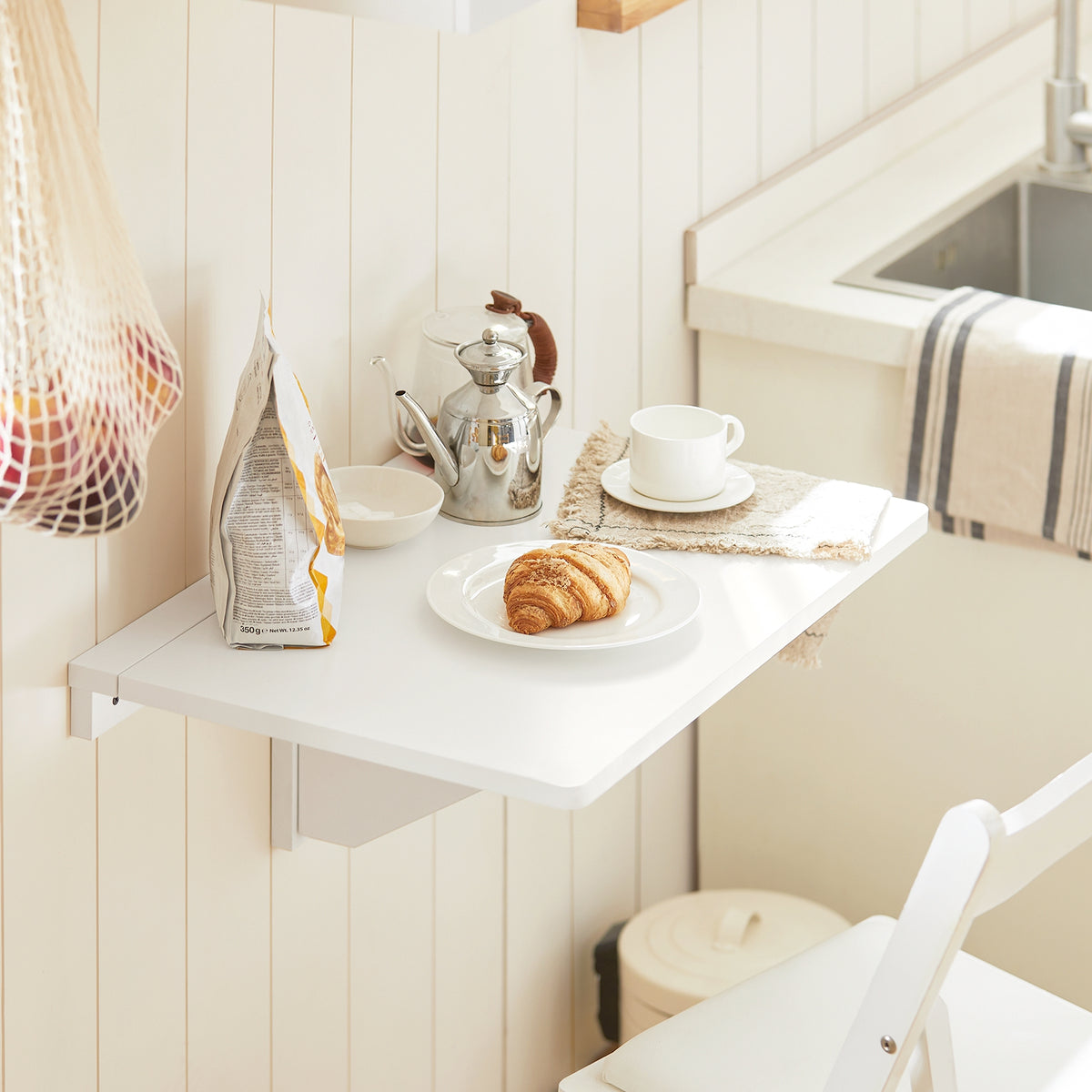 SoBuy FWT03-W wall-mounted folding table in use as kitchen dining table – lifestyle scene
