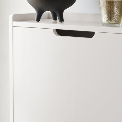 Hidden handle on cabinet door for a sleek look and space-saving design.