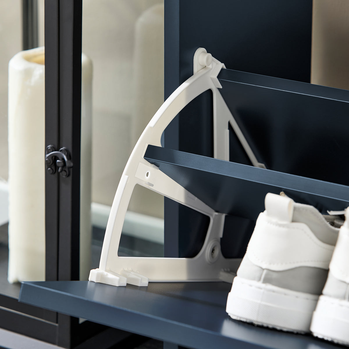 Flip drawer open showing 2-tier shoe rack inside blue cabinet.
