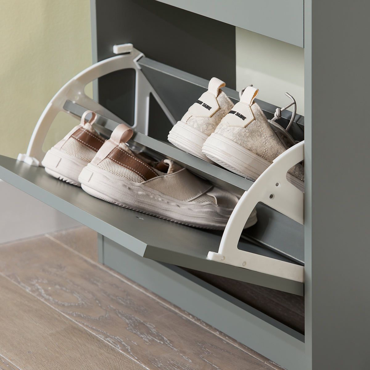 Flip drawer open on grey shoe cabinet showing 2-tier internal rack.