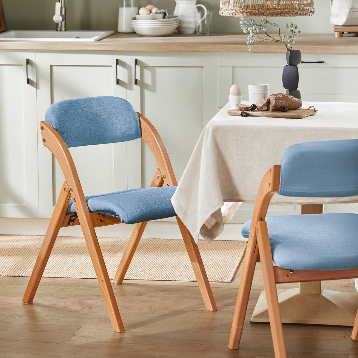 SoBuy FST92-BL blue ergonomic folding chair in dining room setting – 120kg load capacity space-saving chair