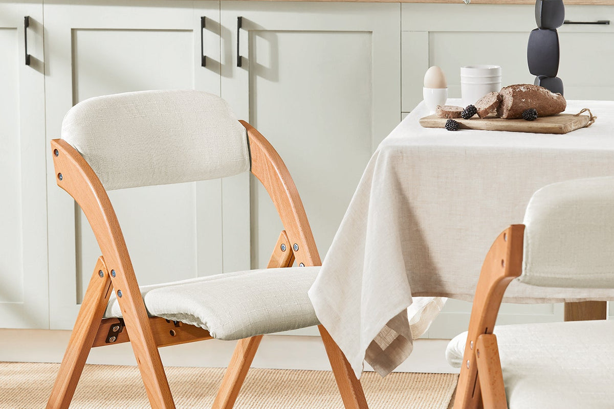 SoBuy FST92-W white ergonomic folding chair in dining room setting – 120kg load capacity space-saving chair
